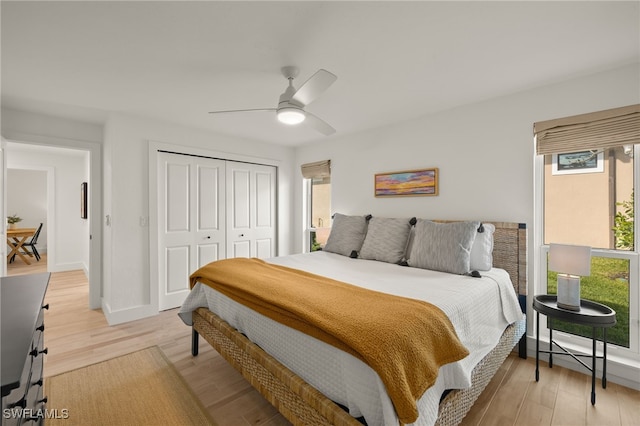 bedroom featuring light wood-type flooring, a closet, and ceiling fan