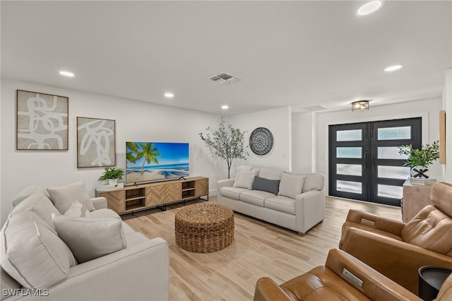 living room featuring light wood-type flooring and french doors