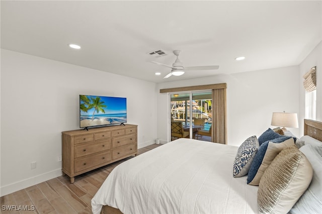 bedroom featuring light hardwood / wood-style floors, ceiling fan, and access to outside