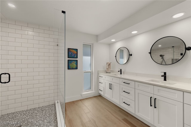 bathroom with vanity, an enclosed shower, and wood-type flooring