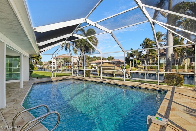 view of pool featuring glass enclosure and a patio area