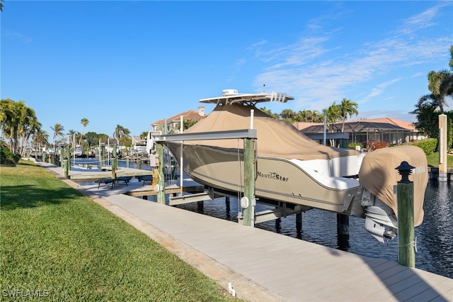 view of dock with a yard and a water view