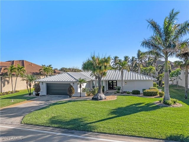 view of front of property featuring a garage and a front lawn