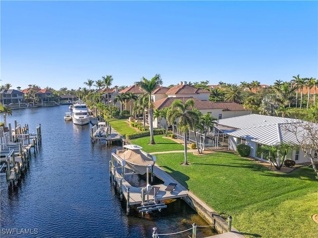 dock area featuring a lawn and a water view