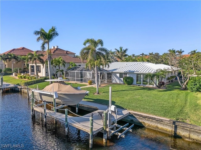 view of dock with a yard, a water view, and glass enclosure