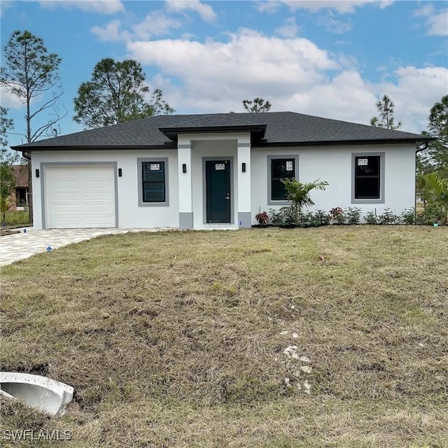 view of front of home with a garage and a front yard