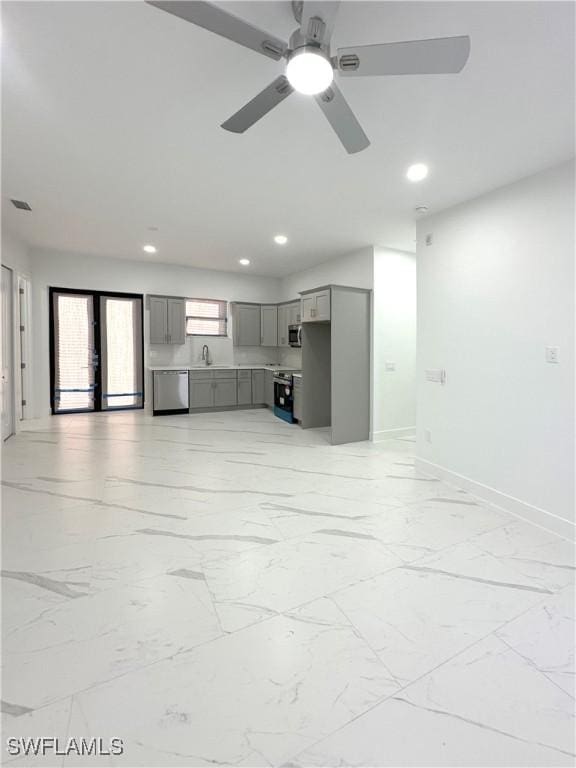 unfurnished living room with sink and ceiling fan