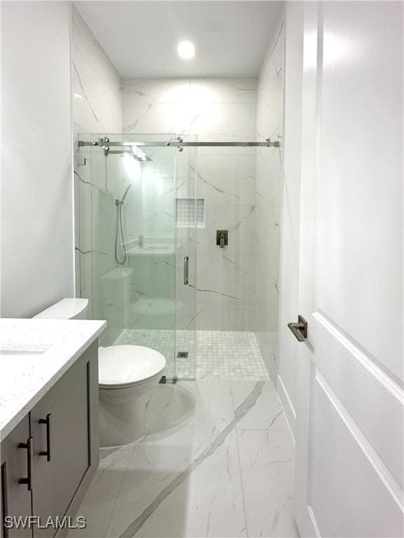 bathroom featuring vanity, an enclosed shower, and toilet