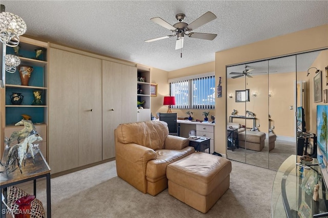 interior space with carpet, ceiling fan, and a textured ceiling