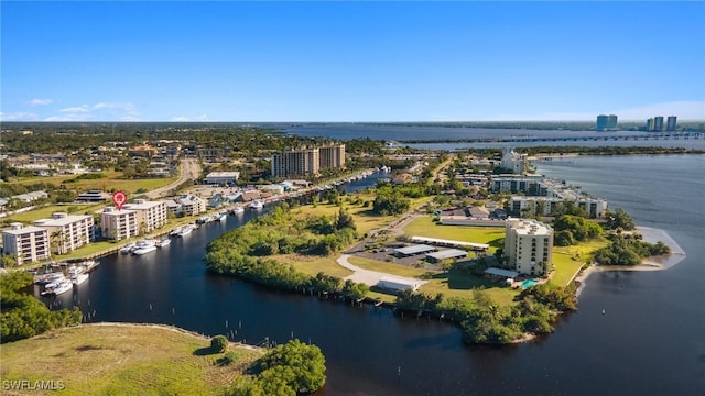 birds eye view of property featuring a water view and a city view