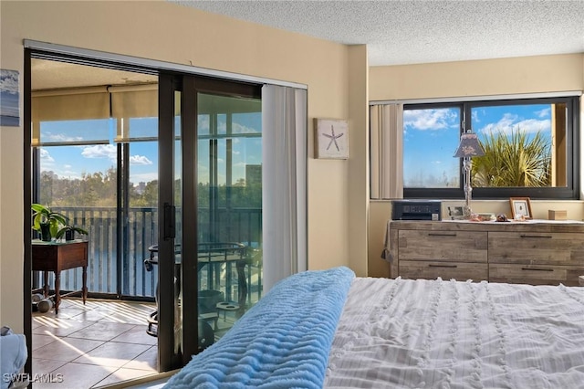 tiled bedroom featuring access to exterior and a textured ceiling