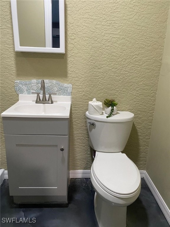 bathroom with toilet and vanity