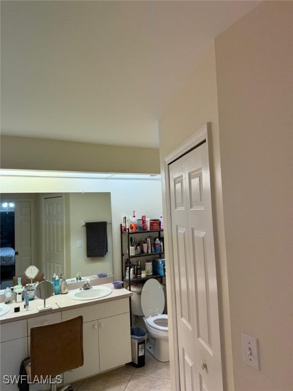 bathroom featuring tile patterned floors, toilet, and vanity