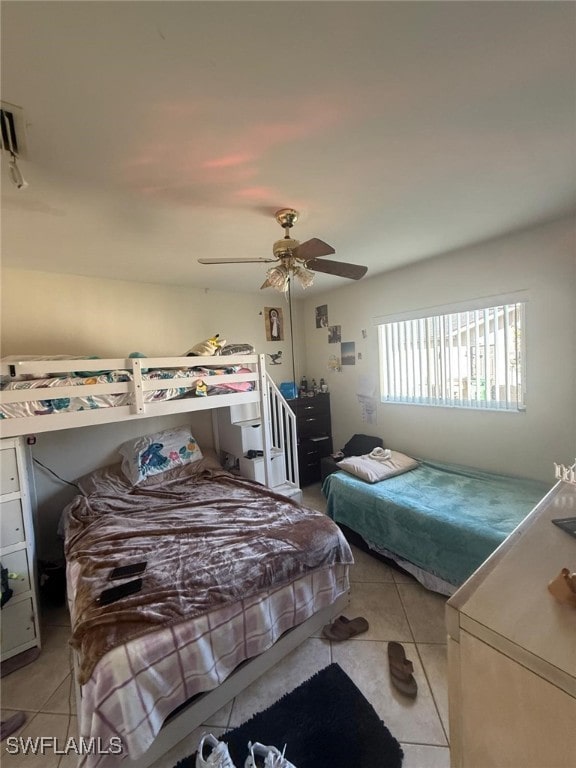 bedroom featuring light tile patterned flooring and ceiling fan