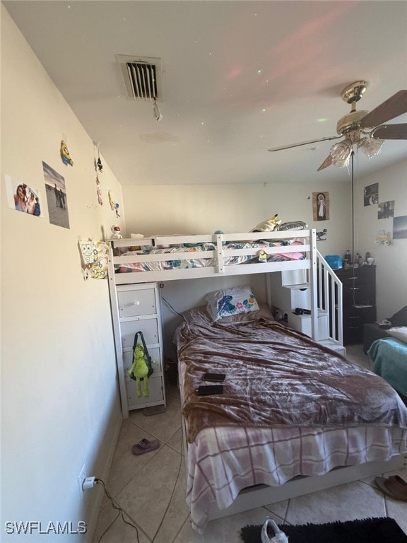 bedroom with ceiling fan and light tile patterned floors