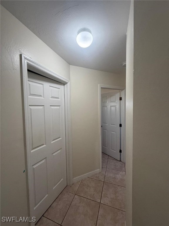 hallway with light tile patterned floors