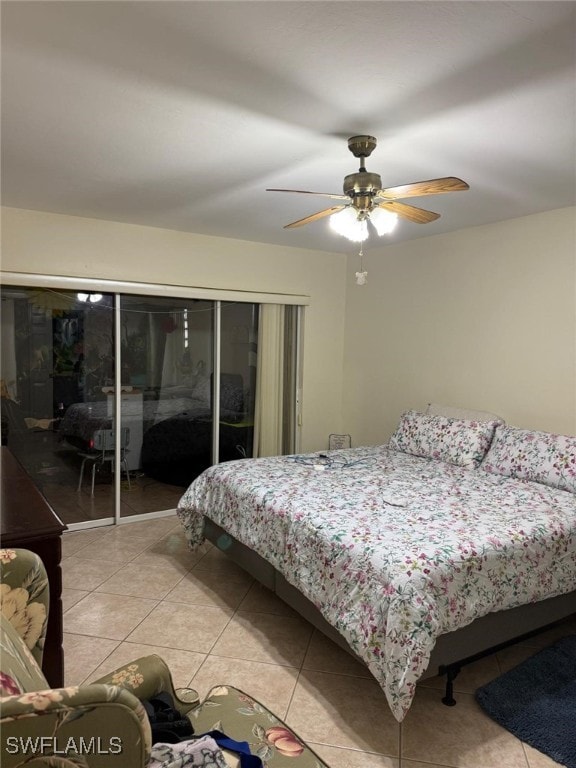 bedroom with light tile patterned floors, ceiling fan, and a closet