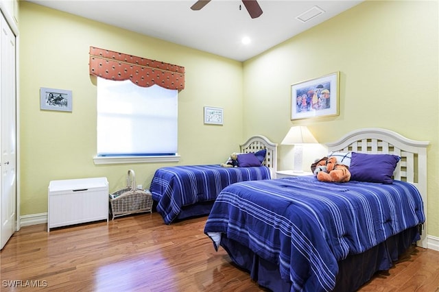 bedroom with wood-type flooring and ceiling fan