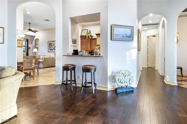 interior space featuring dark hardwood / wood-style floors and a towering ceiling