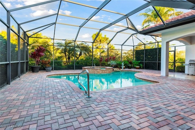 view of pool with an in ground hot tub, a lanai, a grill, and a patio