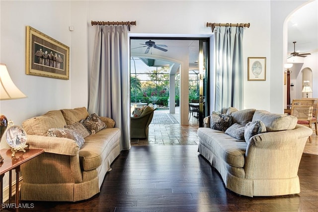 living room with dark wood-type flooring and ceiling fan