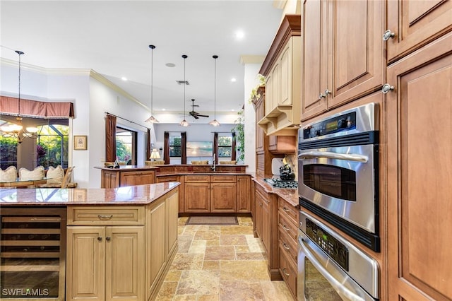 kitchen featuring hanging light fixtures, wine cooler, light stone counters, and kitchen peninsula