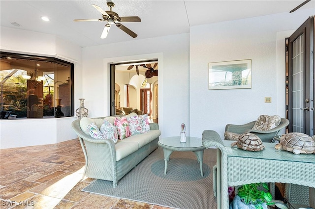 interior space with ceiling fan