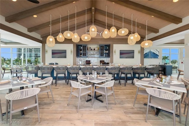 dining space with wood ceiling and lofted ceiling with beams