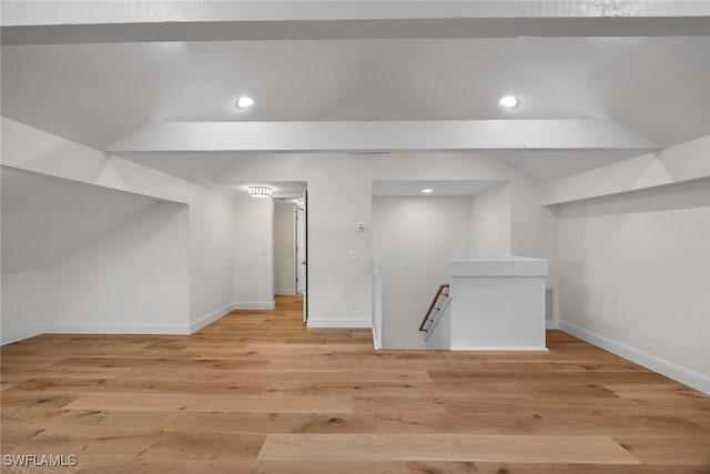 additional living space featuring vaulted ceiling, recessed lighting, light wood-style flooring, and baseboards