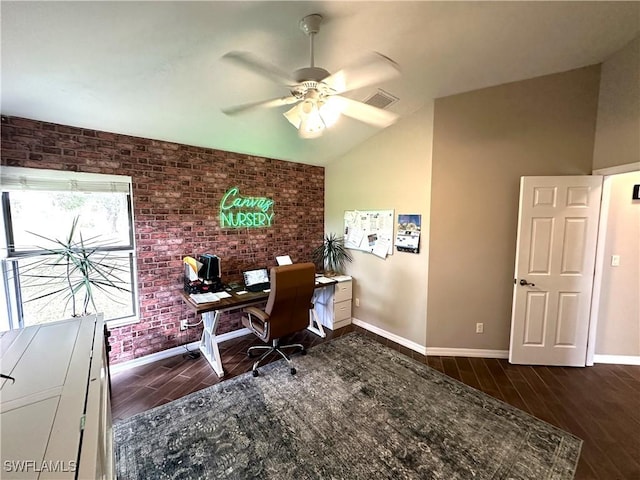 home office featuring brick wall, dark wood-type flooring, lofted ceiling, and ceiling fan