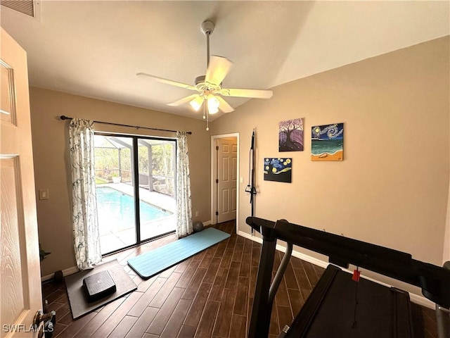 workout room featuring vaulted ceiling and ceiling fan