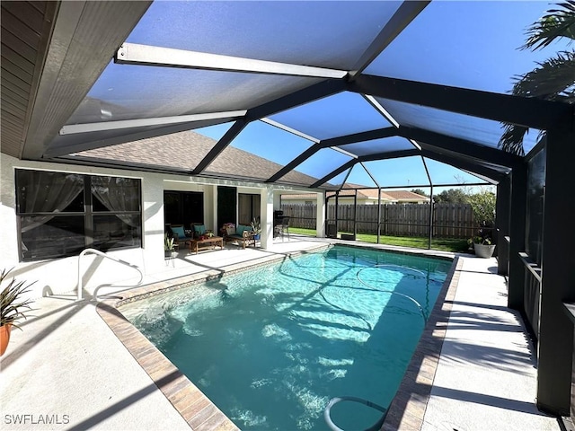 view of swimming pool featuring a patio area and glass enclosure