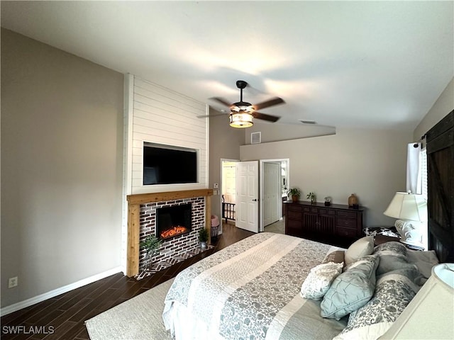 bedroom featuring vaulted ceiling, a fireplace, and ceiling fan