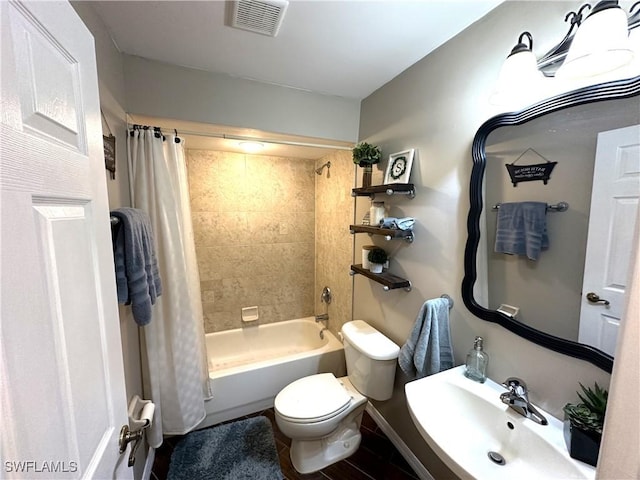 full bathroom with shower / bath combo, sink, and toilet