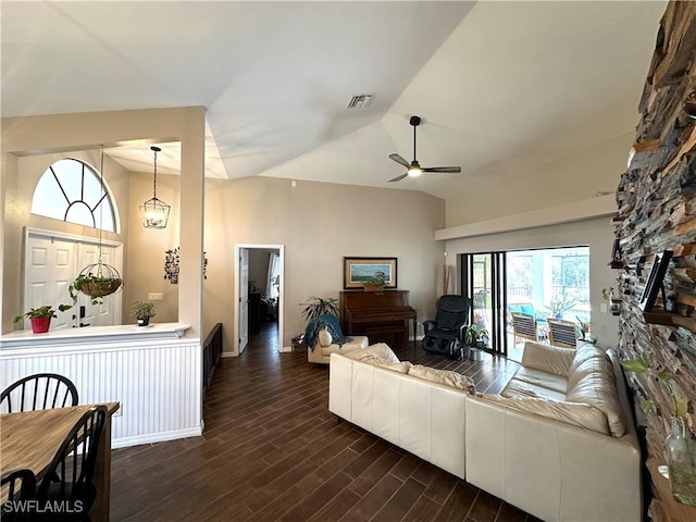 living room featuring vaulted ceiling, dark hardwood / wood-style floors, and ceiling fan