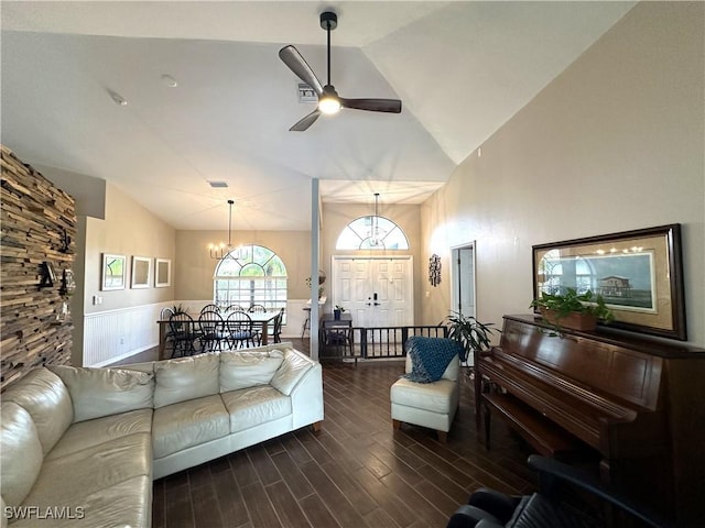 living room with vaulted ceiling and ceiling fan with notable chandelier