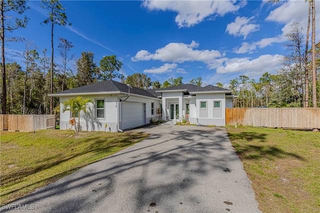 view of front of home featuring a garage and a front lawn