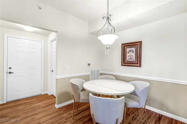 dining space featuring wood-type flooring