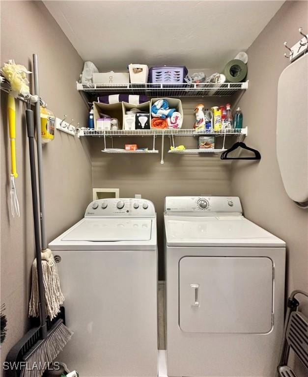 clothes washing area featuring independent washer and dryer