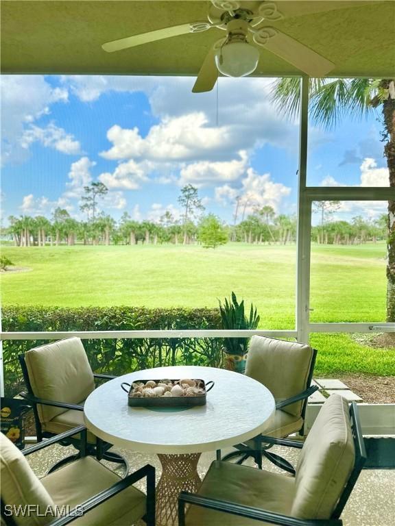 sunroom / solarium featuring ceiling fan