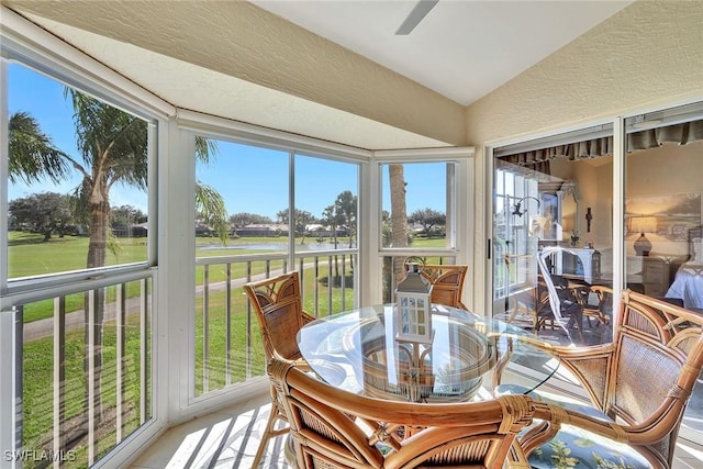 sunroom featuring vaulted ceiling and ceiling fan