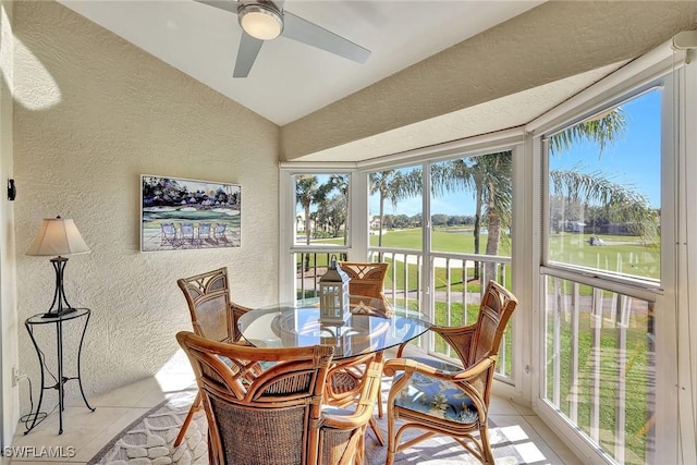 sunroom featuring lofted ceiling and ceiling fan