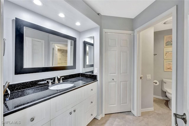 bathroom with tile patterned floors, vanity, and toilet