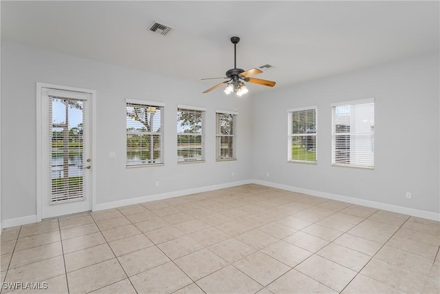 spare room featuring light tile patterned floors and ceiling fan