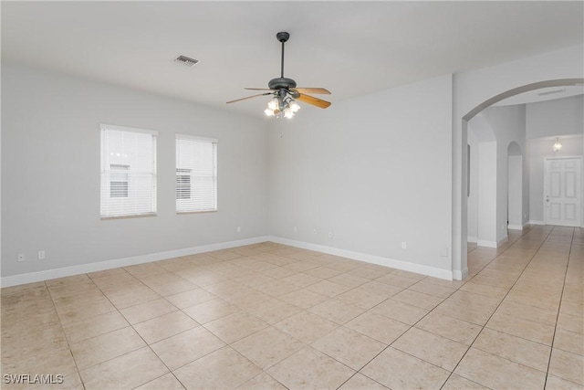 spare room featuring light tile patterned flooring and ceiling fan