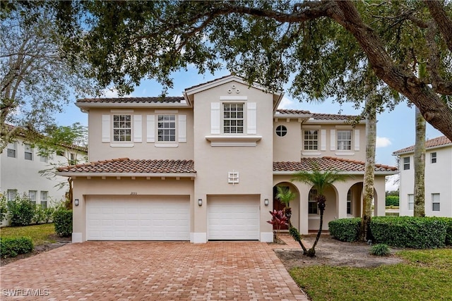 mediterranean / spanish-style home featuring a garage