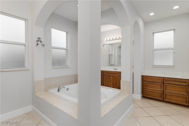 bathroom featuring vanity, tiled bath, and tile patterned floors