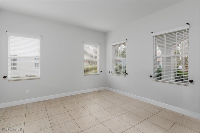 unfurnished room featuring light tile patterned floors