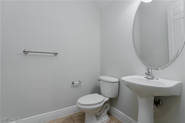 bathroom featuring toilet and tile patterned flooring