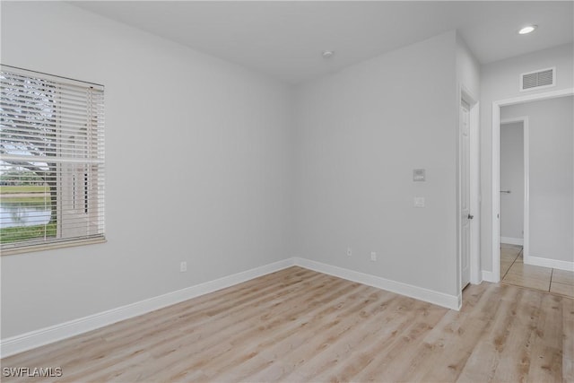 spare room featuring light hardwood / wood-style floors